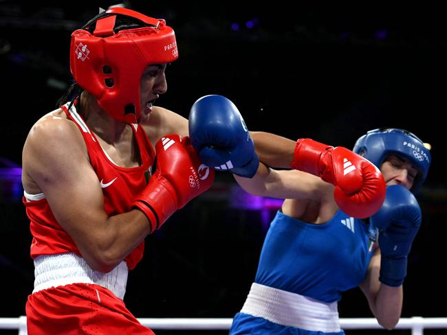 Algeria's Imane Khelif (in red) punches Italy's Angela Carini in the women's 66kg preliminaries round of 16 boxing match during the Paris 2024 Olympic Games at the North Paris Arena, in Villepinte on August 1, 2024. (Photo by MOHD RASFAN / AFP)