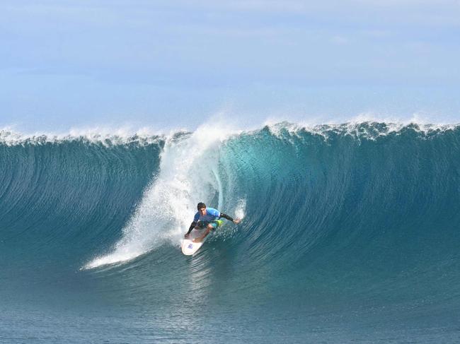 Australia's Jack Robinson gets a barrel in the men's surfing gold medal final. Picture: AFP