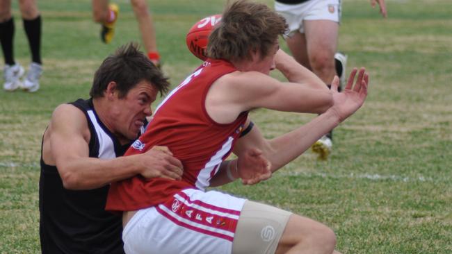 Jamestown-Peterborough’s Greg Farr wraps up Crystal Brook’s Adam Kupsch.