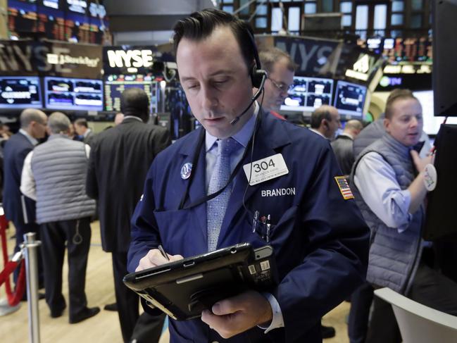 Trader Brandon Barb works on the floor of the New York Stock Exchange, Monday, Nov. 2, 2015. Stocks opened slightly higher on Wall Street as the market comes off its biggest monthly gain in four years. Health care stocks were among the early winners. (AP Photo/Richard Drew)