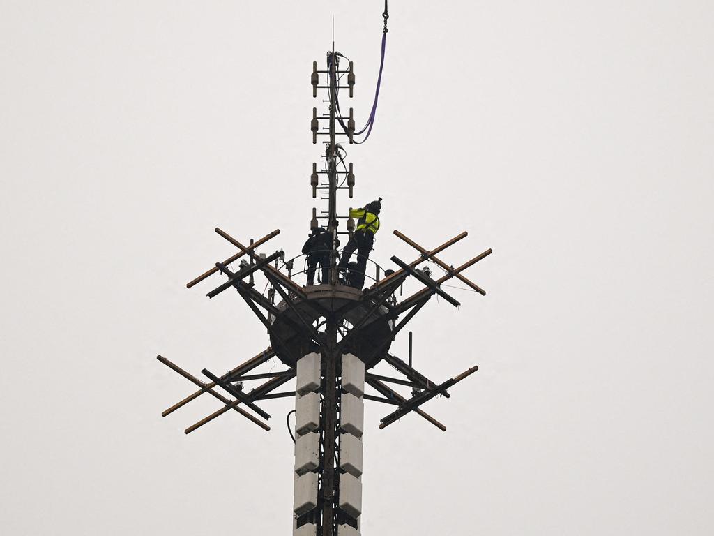 Workers connect the new antenna at the top of the Eiffel Tower in Paris on March 15, 2022. Picture: Christophe Archambault/AFP