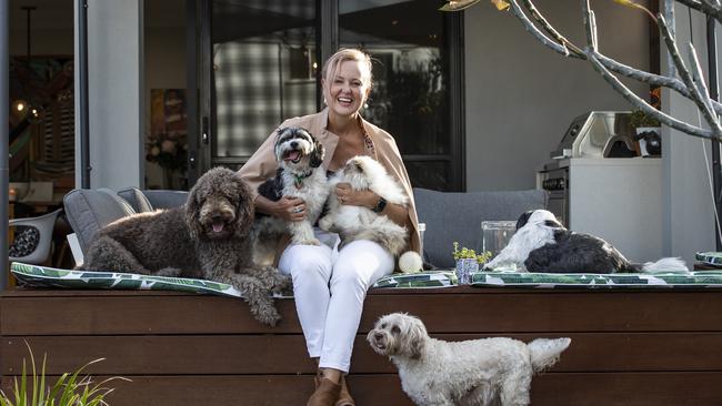 Fur brood: Tracey Vieira with her dogs Drover (shih tau), Amber (terrier mix), Charlie (mix) and Burger (Labradoodle), and Pickles the cat. Picture: Mark Cranitch.