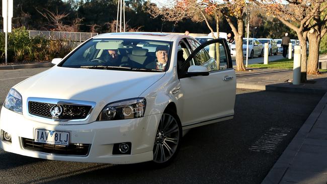 Comcars have changed from the traditional white to dark grey. Picture: Kym Smith