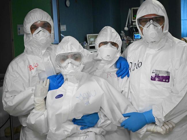 Health workers pose at the end of their shift at the San Filippo Neri hospital in Rome. Picture AFP.