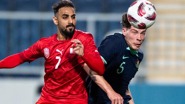 ABU DHABI, UNITED ARAB EMIRATES - JANUARY 6: Bahrain's Ali Madan (L) fights for the ball with Australia's Jordan Jacob Bos in the international friendly on January 6, 2024 in Abu Dhabi, United Arab Emirates. (Photo by Martin Dokoupil/Getty Images)