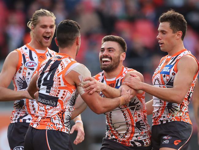 Giants Stephen Coniglio celebrates kicking a goal with teammates during AFL match between the GWS Giants and Gold Coast Suns at Giants Stadium. Picture. Phil Hillyard