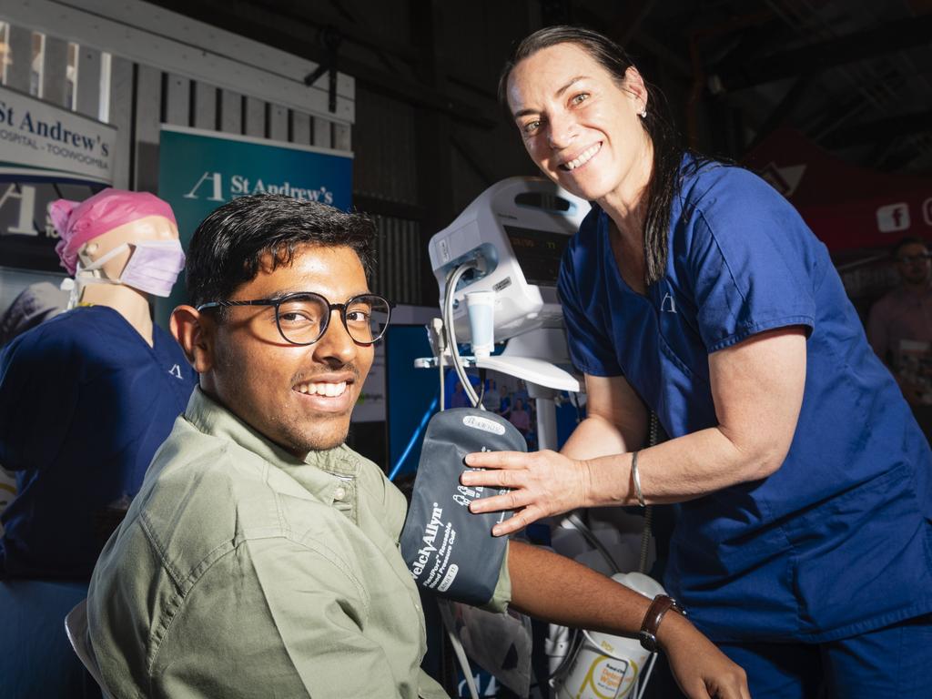 Job seeker Adhith Sivaharen with a blood pressure cuff demonstrated by St Andrew's Hospital assistant in nursing Linda Von Nida. Picture: Kevin Farmer