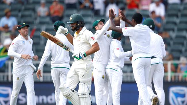 South African bowler Kagiso Rabada (R) celebrates the dismissal of Australian batsman Joe Burns.