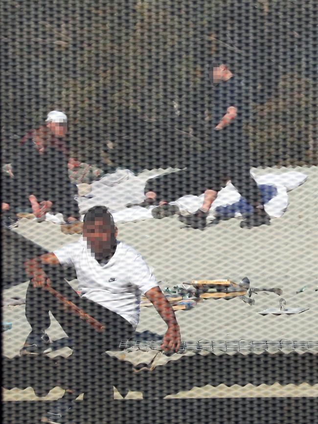 Inmates from the Frank Baxter Juvenile corrections centre Kariong taunt police from the roofs of various buildings . Some are armed with poles tennis rackets ect. Picture: John Grainger