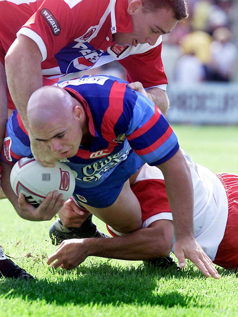 Corey Parker is wrapped up in a tackle. Picture: Derek Moore