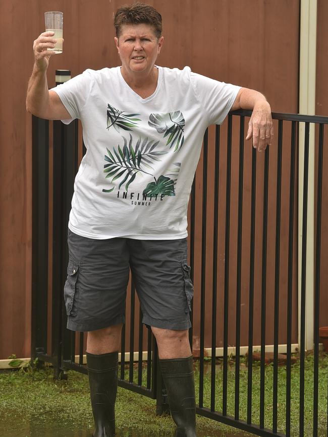 Leanne Dobbin, standing in sewage in her backyard, is one of many Wulguru residents that experiences poonami when the rain comes. Picture: Evan Morgan