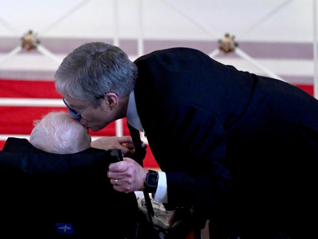 James "Chip" Carter kisses the head of his father, former US President Jimmy Carter, during the service. Picture: AFP