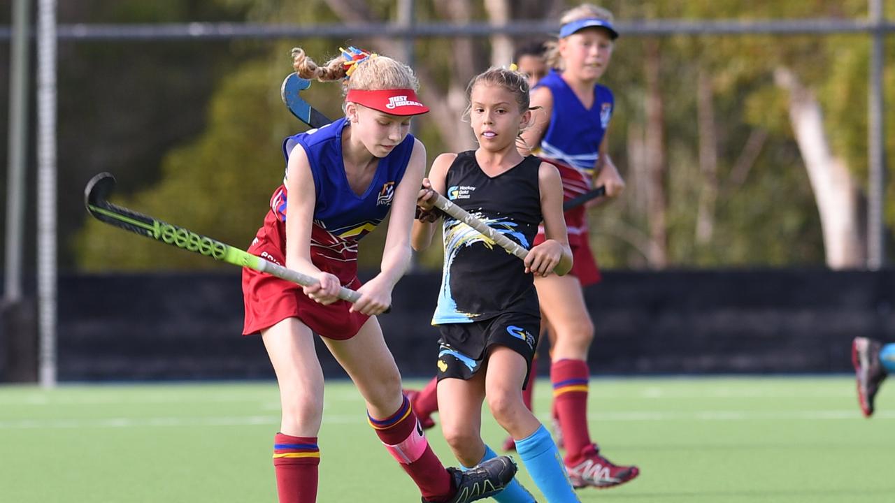 Eliza White (Brisbane) lines up a shot in front of Gold Coast's Camryn Mathison earlier in their careers as under 13 players