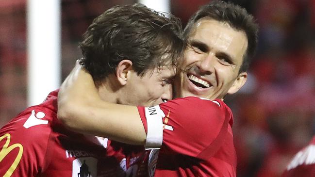 Craig Goodwin, left, celebrates his second and match-winning goal for Adelaide United. Picture Sarah Reed