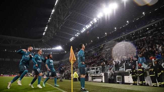 Real Madrid's Portuguese forward Cristiano Ronaldo (R) celebrates as Juventus fans applaud.