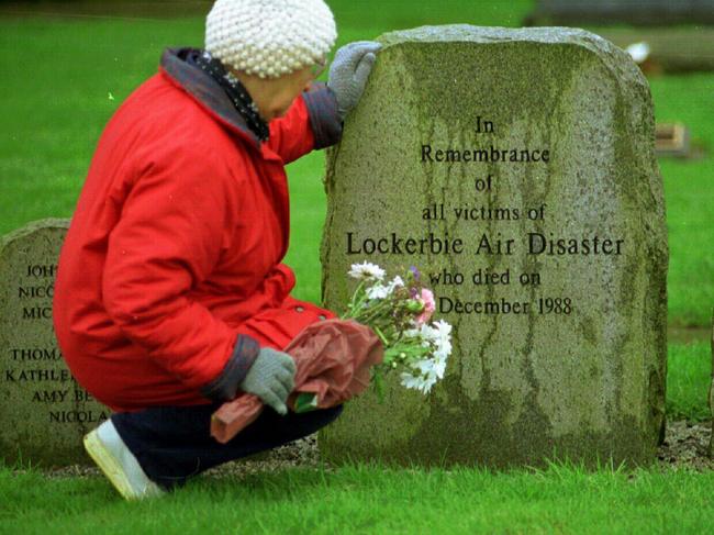  A woman pays her respect in the memorial garden for the Lockerbie victims on the tenth anniversary of the bombing, in 1998.