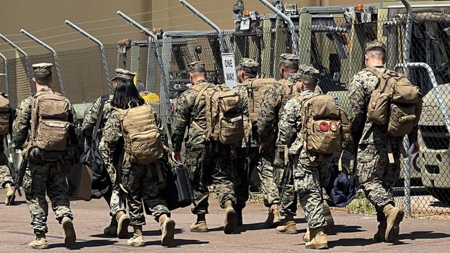 A group of Marines make their way for minibus after touching down at RAAF Base Darwin. Picture: Harry Brill.