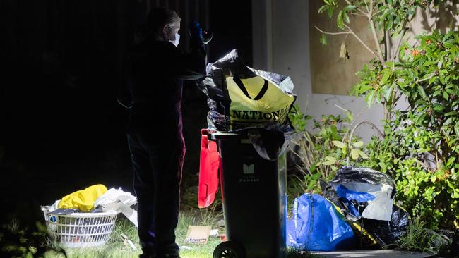 Missing Persons Squad detectives and forensics at a crime scene along Railway Parade Chadstone and also at a property on Binalong Avenue, Chadstone. Police look through a garbage bin. Picture: Jason Edwards