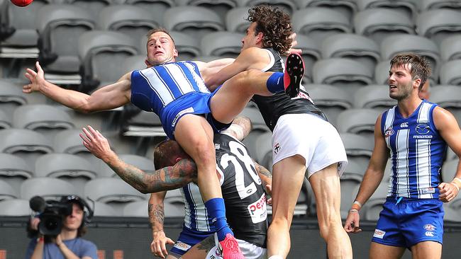 Josh Walker of the Kangaroos lands awkwardly after trying to mark. Pic: Michael Klein