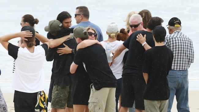 Family and friends hold a memorial for Dylan Carpenter at Fingal beach where the young surfer died. Picture: Glenn Hampson