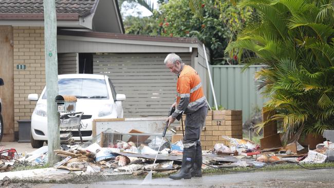 A man cleaning up in Mullumbimby in March. Picture: Liana Boss