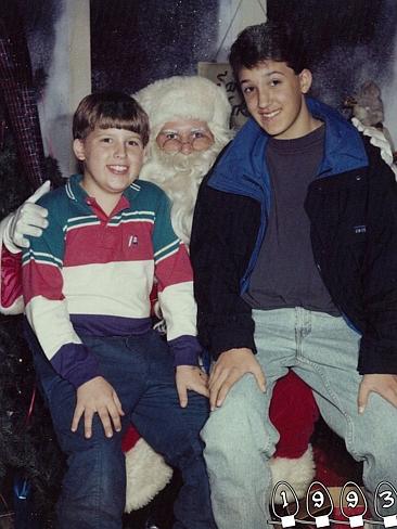 1993 ... Mike's braces are finally off, as they pose with Santa again. Picture: Ma...