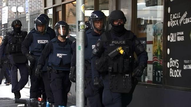 Police officers during Kings Cross area drugs raids yesterday.