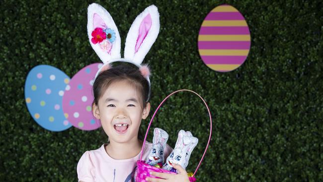 Indooroopilly Shopping Centre is giving away 1.8 tonnes of free chocolate this Easter. Anda Xie, 5, from Kenmore tries some of the freebies. Picture: AAP/Renae Droop