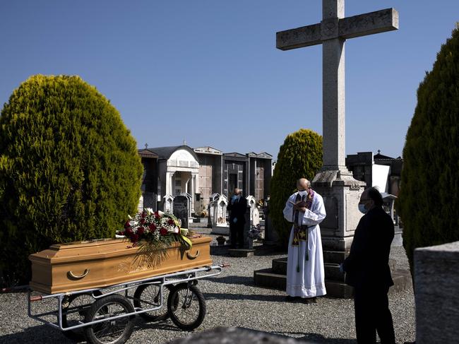 A priest conducts a funeral in Italy. Picture: AFP