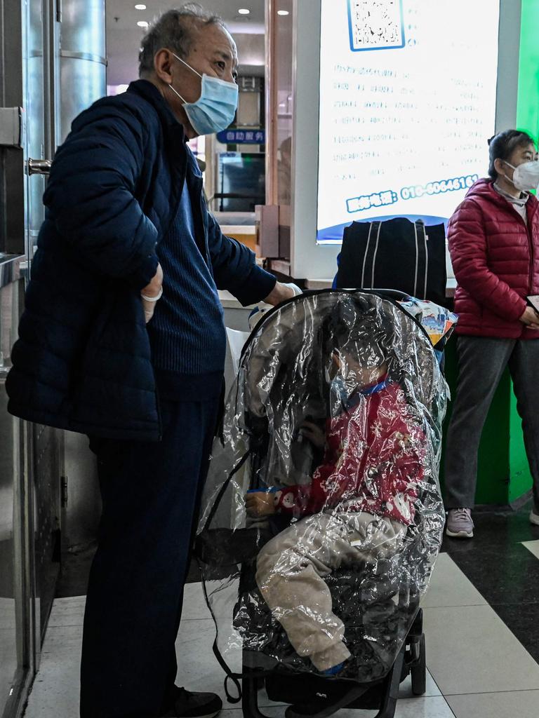 A grandparent with a child at a hospital in China. (Photo by Jade Gao / AFP)