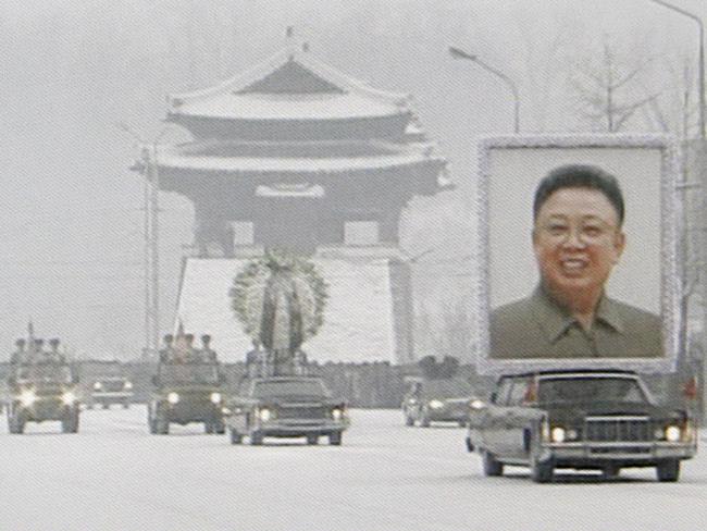 A huge portrait of late North Korean Leader Kim Jong Il being transported during a funeral procession in snowy Pyongyang in 2011.