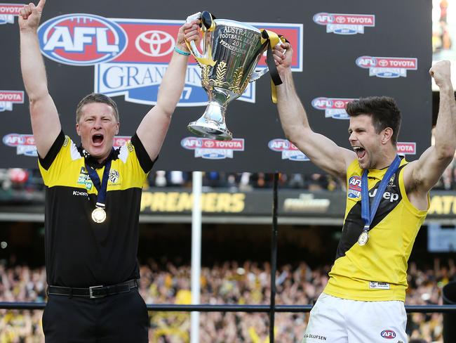 Tigers coach Damien Hardwick and captain Trent Cotchin hold the premiership cup aloft. Picture: Michael Klein<br/>