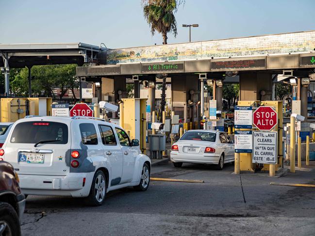 Cars wait to cross into Brownsville, Texas from Matamoros, Mexico. Picture: Sergio Flores/AFP