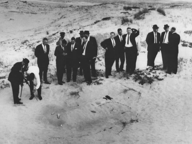 1965: Detectives and other police at the scene of the murder of two teenage girls at Wanda Beach, NSW. Christine Sharrock and her best friend Marianne Schmidt, both 15, were killed on the beach and buried in the sand. The case, known as the Wanda Beach Murders, remains unsolved. File picture