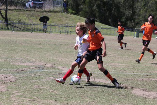 The Premier Invitational football tournament on the Gold Coast. Brisbane Roar Orange v TFC Brisbane White under-13s in action. Picture: Mike Batterham.