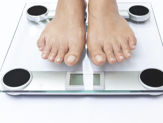 Generic photo of feet on bathroom scales. Picture: iStock