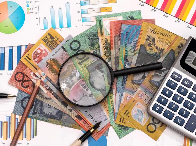 Business graphs with australian dollars, magnifier, pen and calculator Australian money tax generic