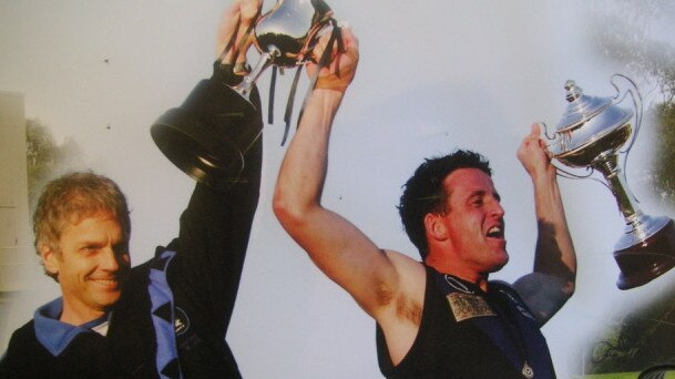 Coach John Kanis and captain Quinton Gleeson hoist the 2004 premiership cup.