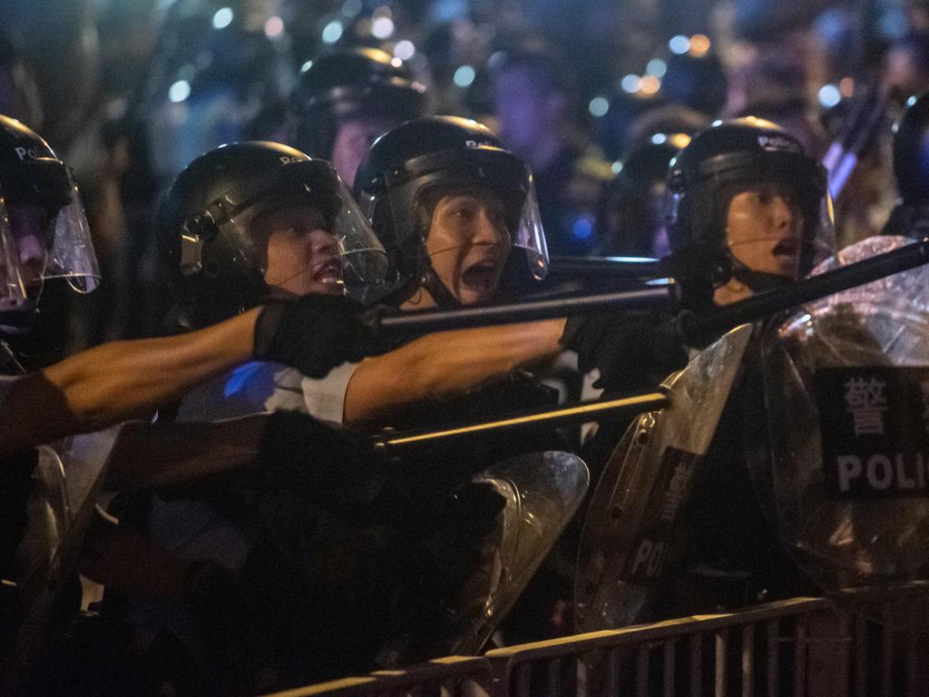 Riot police shout at protesters during clashes after a rally against the controversial law proposal on Sunday. Picture: Philip Fong / AFP