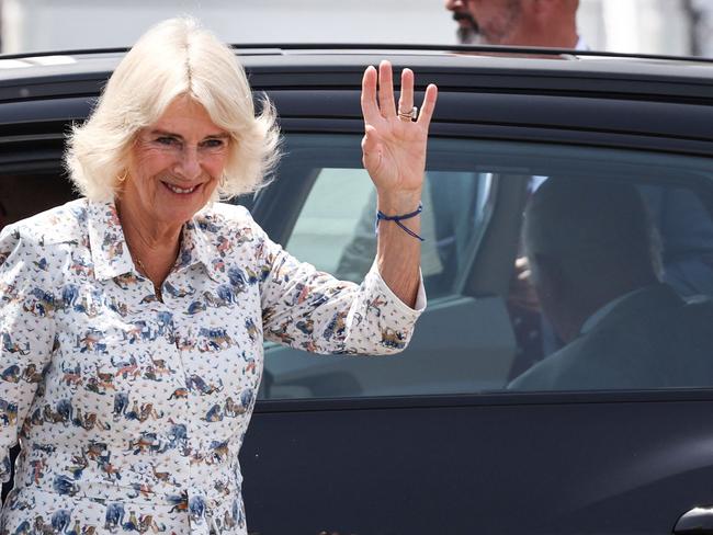 Britain's Queen Camilla waves as she and Britain's King Charles III prepare to depart from Sydney Airport. Picture: AFP