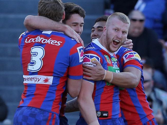 NEWCASTLE, AUSTRALIA - JULY 21:  Mitch Barnett of the Knights celebrates his try with team mates during the round 19 NRL match between the Newcastle Knights and the Gold Coast Titans at McDonald Jones Stadium on July 21, 2018 in Newcastle, Australia.  (Photo by Ashley Feder/Getty Images)