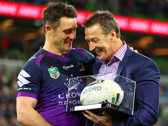 Storm coach Craig Bellamy presents Cooper Cronk with the match ball after Cronk played his final home match.