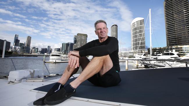 Sam Newman on his boat at Docklands, before it sunk. Picture: David Caird