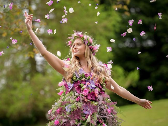 A model, representing Flora, the Goddess of Spring and Flowers, scatters petals while wearing a floral dress by florist Helen James at an event to launch the Harrogate Flower Show. Picture: Christopher Furlong/Getty Images