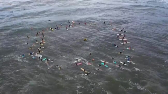 Moffat Beach surfers paddle out for John Koda