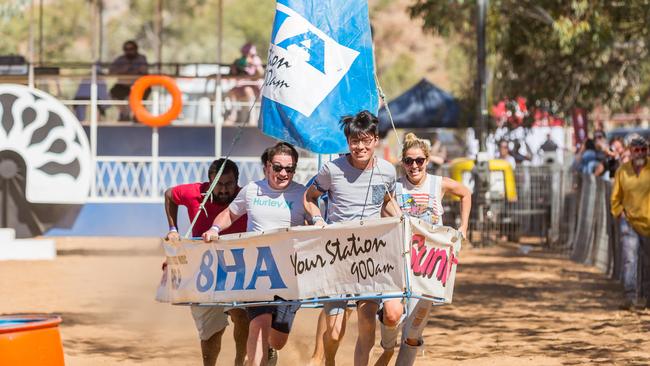 The team from the Alice Springs Hospital on their way to winning the mini yacht race at the Henley on Todd Regatta. Photo: EMMA MURRAY