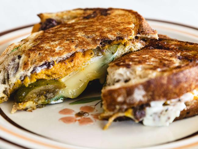 Plain Jane’s Pumpkin and Zucchini toastie comprises toasted slabs of sourdough which sandwich sweet roasted pumpkin with salty olive tapenade and several slices of mild and melty provolone cheese. Picture: Linda Higginson