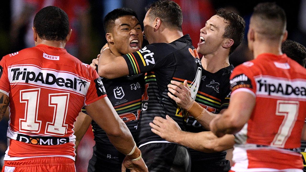 Brian To'o of the Panthers (left) celebrates with teammates after scoring a try.