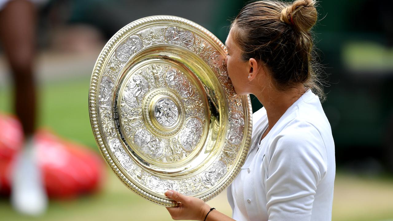 Simona Halep kisses the trophy after beating Serena Williams.