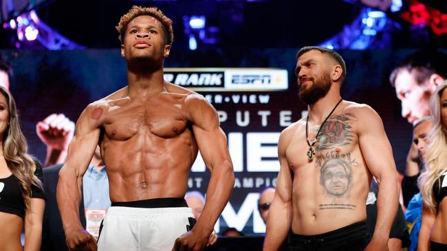 Devin Haney (L) and Vasyl Lomachenko of Ukraine (R) pose for photos at the weigh in.